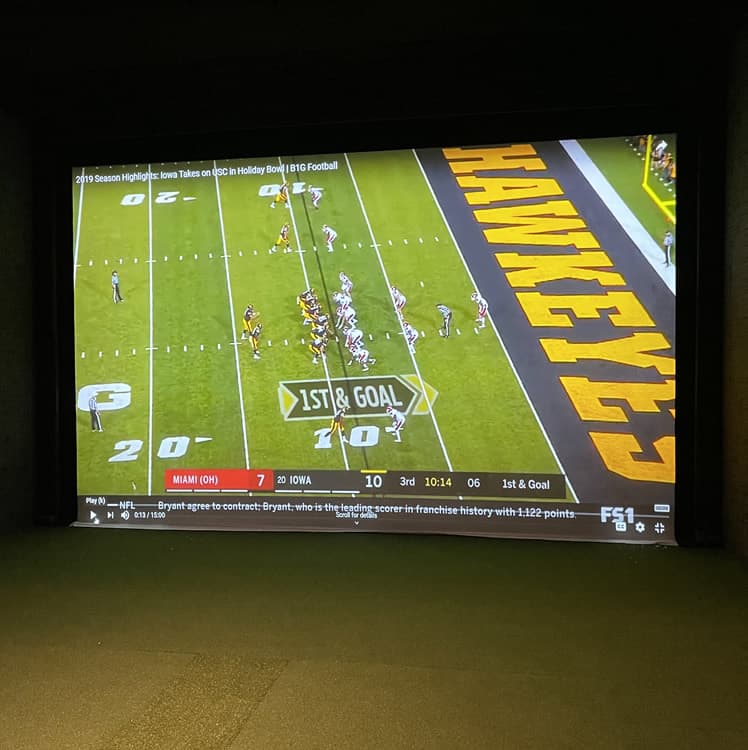 Iowa Hawkeyes football game streaming on a simulator screen